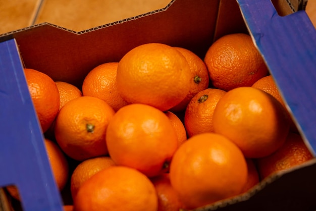 Oranges in a cardboard box Lots of orange storage sale concept