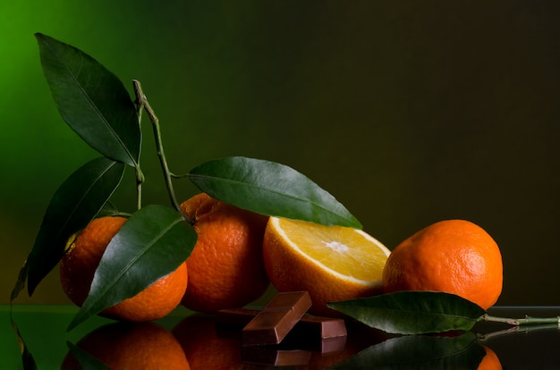 Oranges and chocolate on a dark background