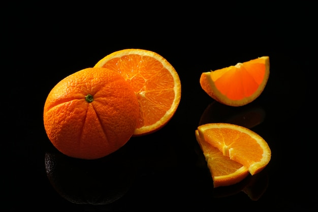 Oranges fruits on a black surface