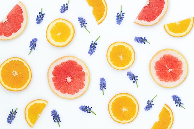 oranges grapefruits and blue flowers on the gray surface