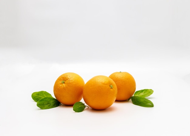 Oranges and leaves isolated on a white background