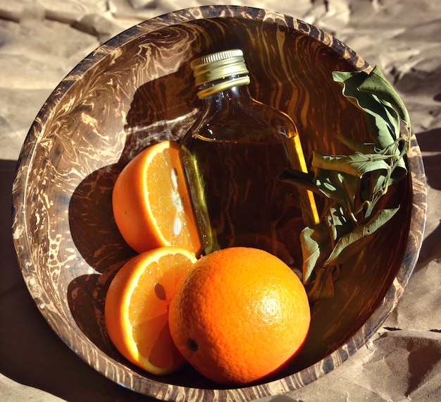 Oranges and oil in a wooden cup.