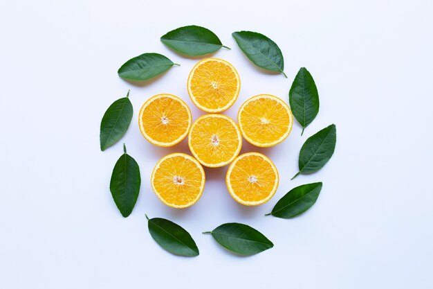 Oranges with green leaves isolated on white background. Top view