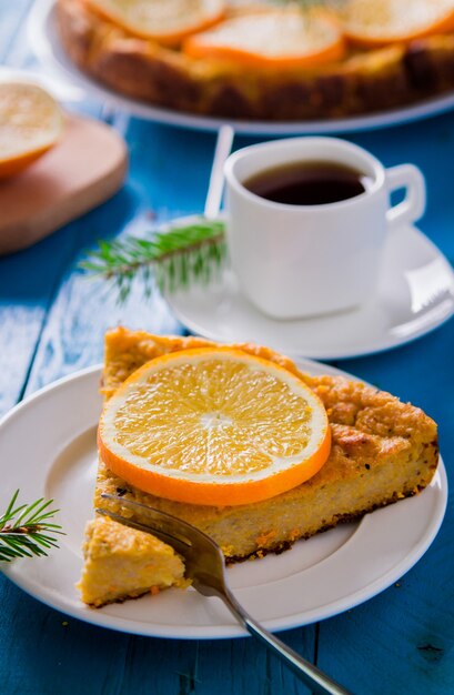 Oranje cake met kopje koffie close-up