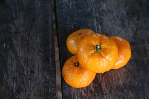 Oranje fruit op oud houten bureau.