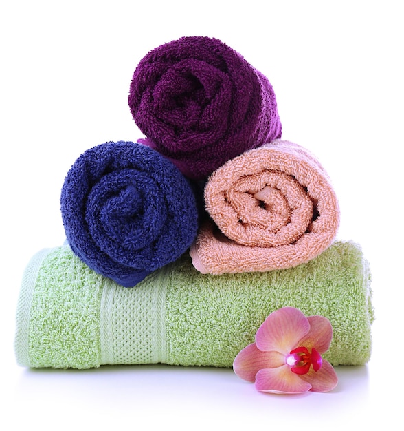 Orchid flower and towel rolls isolated on white