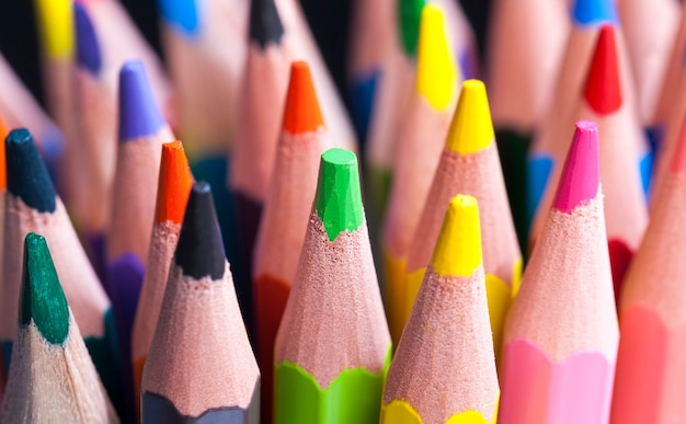 Ordinary colored wooden pencil with soft lead of different colors for drawing and creativity, close up of pencils after sharpening and using, pencil made of natural materials safe for children