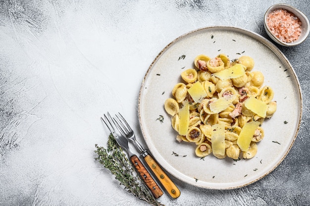 Orecchiette homemade carbonara pasta with pancetta, egg, hard parmesan cheese and cream sauce.