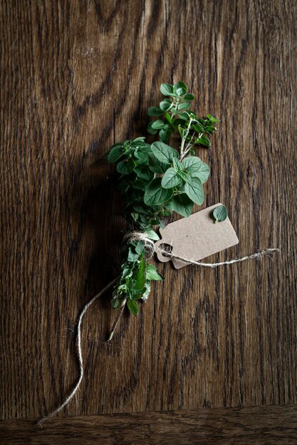 Oregano bouquet fresh from the garden on wooden kitchen table