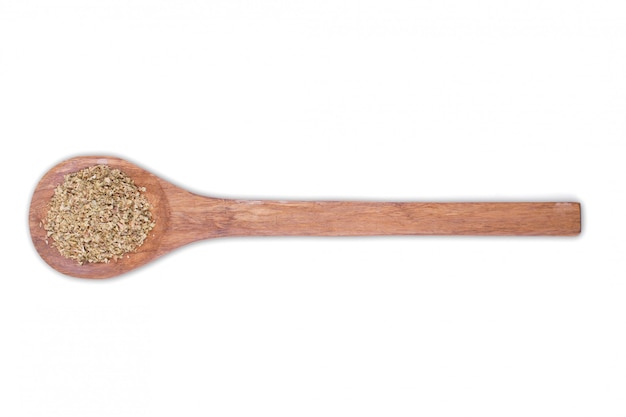 Oregano powder on wooden spoon isolated on white 