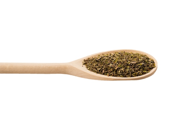 Oregano spice in wooden spoon isolated