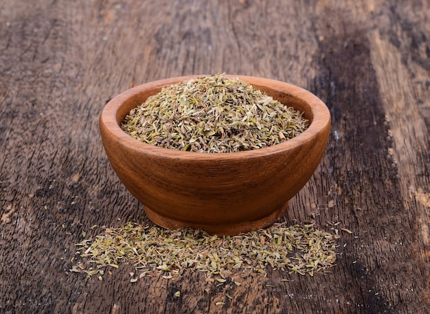 Oregano in wood bowl on wooden