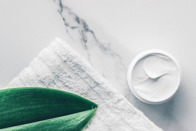 Organic beauty cosmetics on marble home spa flatlay background