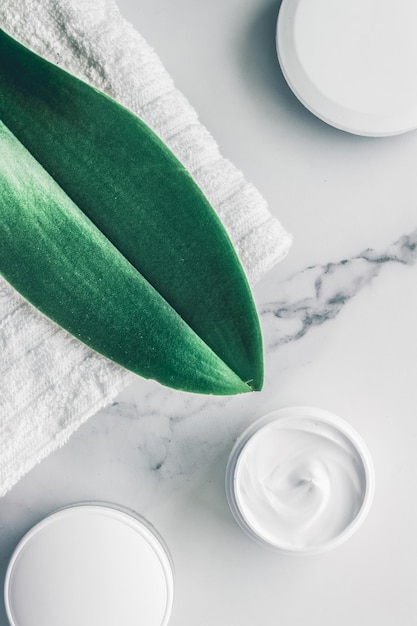 Organic beauty cosmetics on marble home spa flatlay background