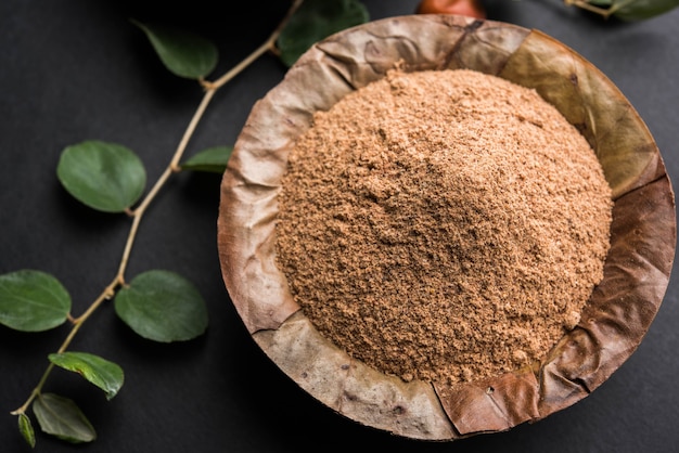 Organic Borkut powder of Indian Jujube ber or berry or Ziziphus mauritiana, which is a type of date. Over moody background, selective focus