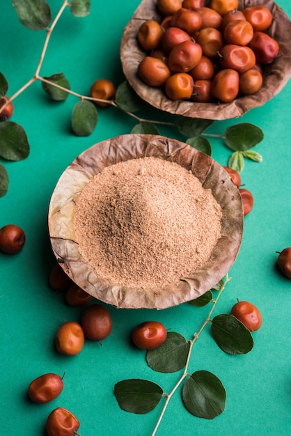 Organic Borkut powder of Indian Jujube ber or berry or Ziziphus mauritiana, which is a type of date. Over moody background, selective focus