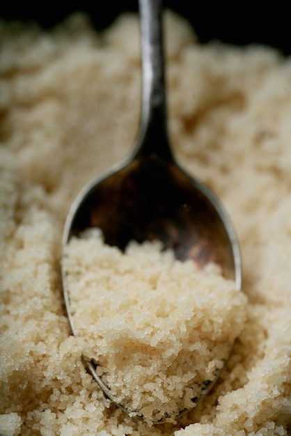 Organic brown sugar in a spoon. Close up