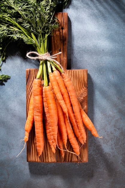 Organic carrot on wood cutting board