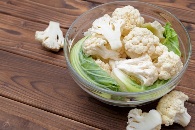 Organic cauliflower on wooden background