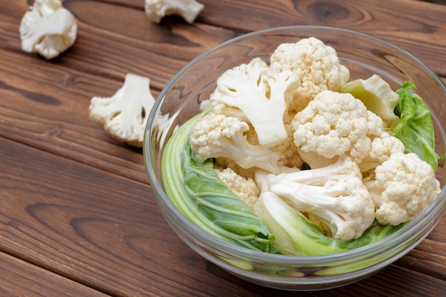 Organic cauliflower on wooden background