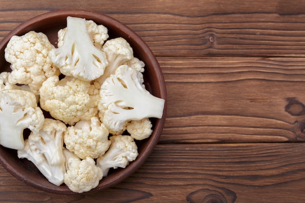 Organic cauliflower on wooden background