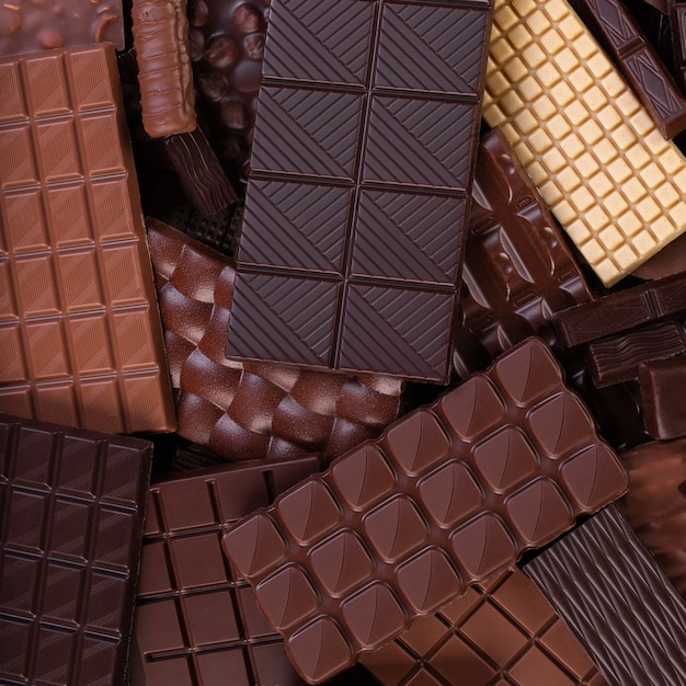 Organic chocolate background, pile of cocoa bars, top view.