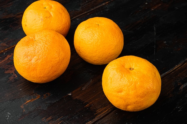 Organic clementine or tangerine set, on old dark  wooden table background