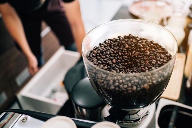 Organic coffee beans into an electric coffee grinder Preparation for making fresh coffee