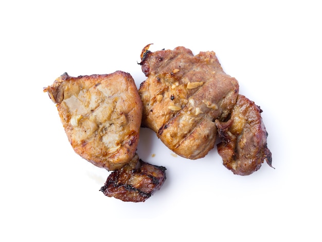 Organic cooked grilled pork chop steak with salt, pepper, garlic and oil in thai style isolated on white