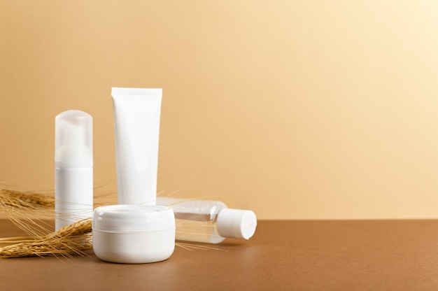 Organic cosmetic white packages with wheat ears composition.