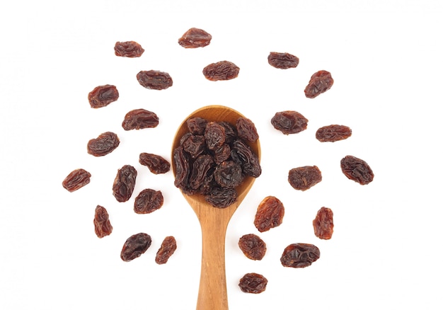 Organic dried raisins in wood spoon