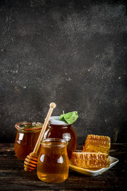 Organic farm honey in jars with honeycombs