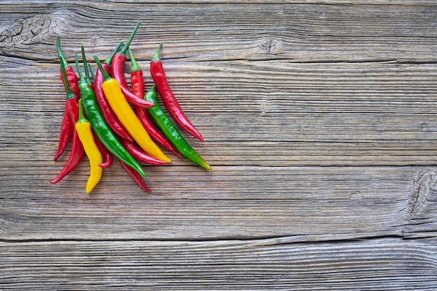 Organic food Bunch of colorful chilli pepper on rustic wooden background