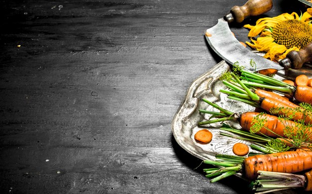 Organic food Fresh carrots on a steel tray on the black chalkboard