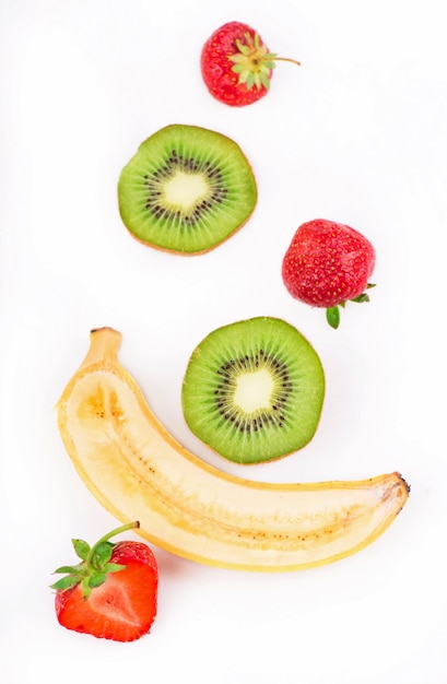 Organic food, healthy food, kiwi, strawberry and bananakiwi, strawberry and banana on a white surface