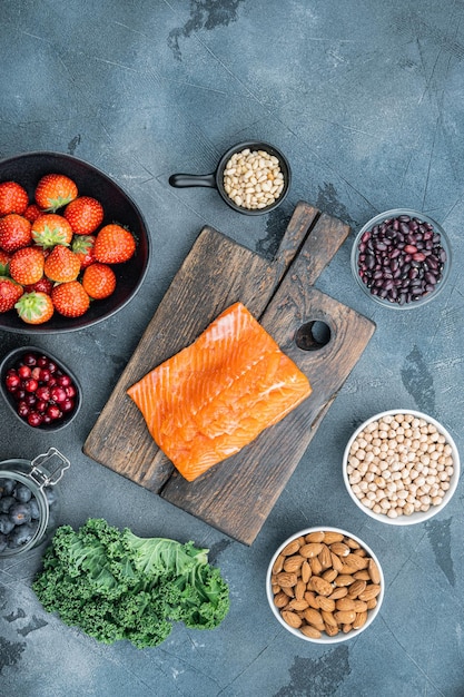 Organic food for healthy nutrition and superfoods, flat lay, on grey background