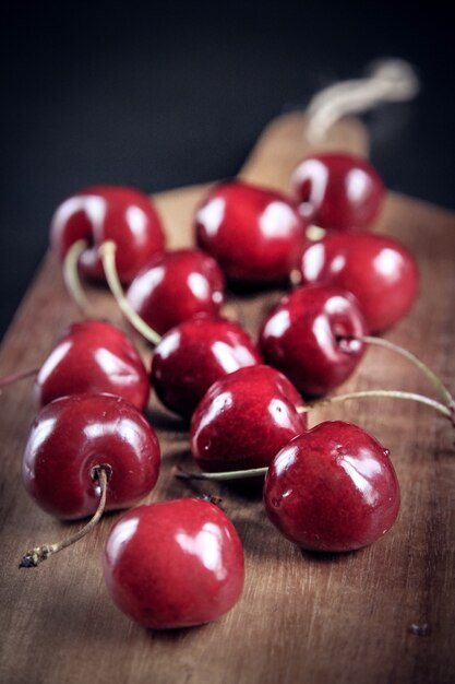 Organic fresh cherries on a wooden cutting board