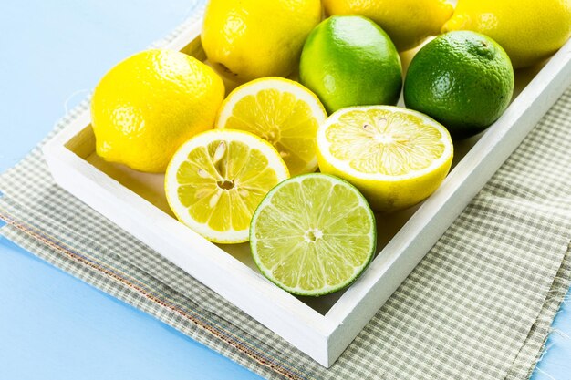 Organic fresh citrus fruit on a white tray.