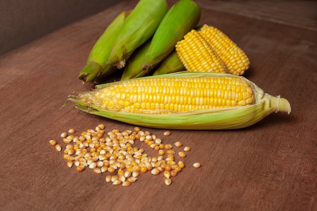 Organic fresh corncobs or corn ears on wood.Food for health. 