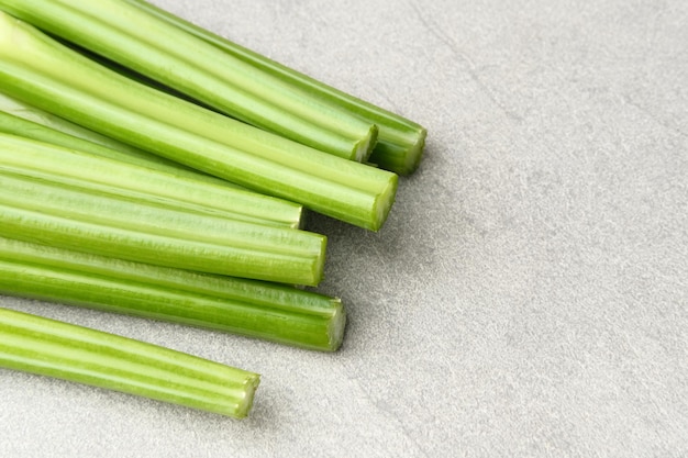 Organic fresh green celery sticks on a grey background Selected focus