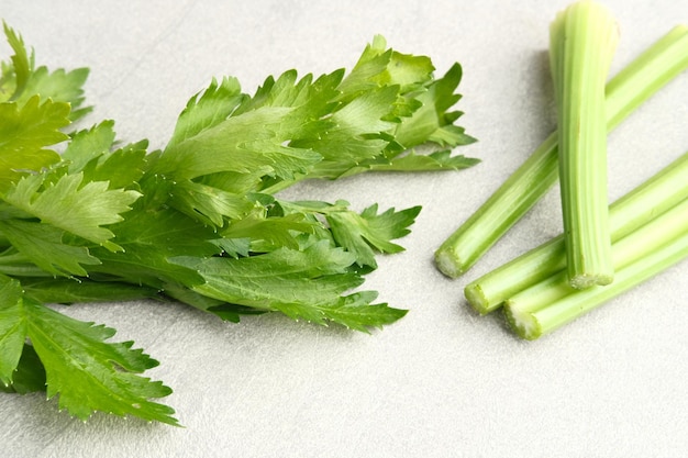 Organic fresh green celery sticks on a grey background Selected focus