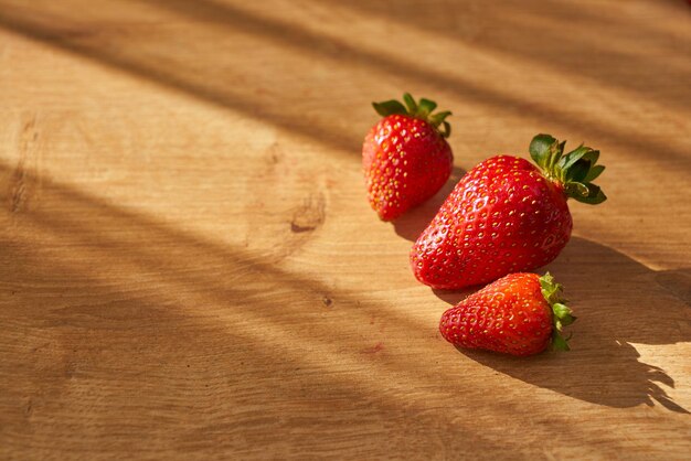 Organic fresh strawberries on a wooden counter