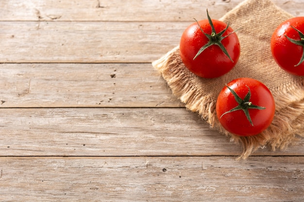 Organic fresh tomatoes on rustic wooden table