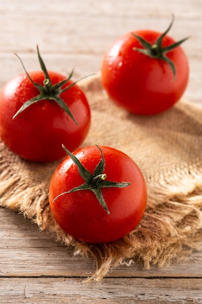 Organic fresh tomatoes on rustic wooden table