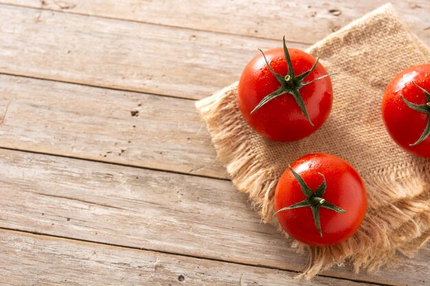 Organic fresh tomatoes on wooden table