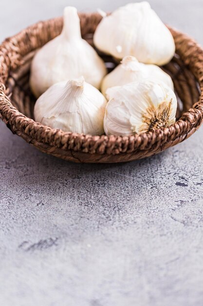 Organic garlic cloves in small basket.