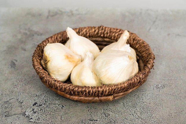 Organic garlic cloves in small basket.