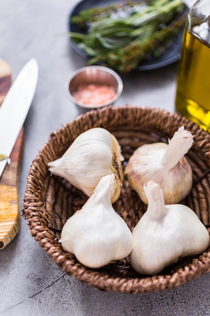 Organic garlic cloves in small wicker basket.