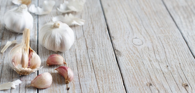 Organic garlic on the old wooden table close up