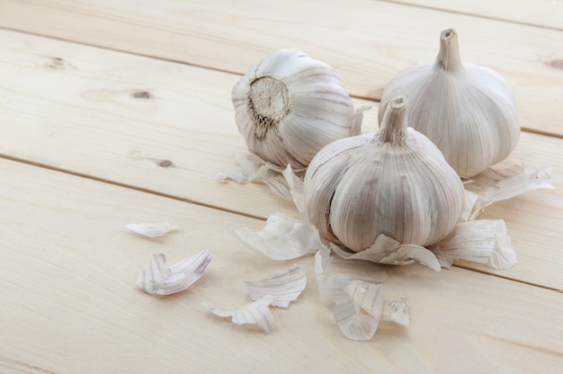 Organic garlic whole and cloves on the wooden background